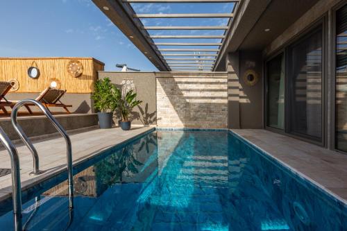 a swimming pool in the backyard of a house at Marje Villas Bodrum in Bodrum City