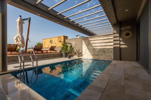 a swimming pool on the roof of a house at Marje Villas Bodrum in Bodrum City