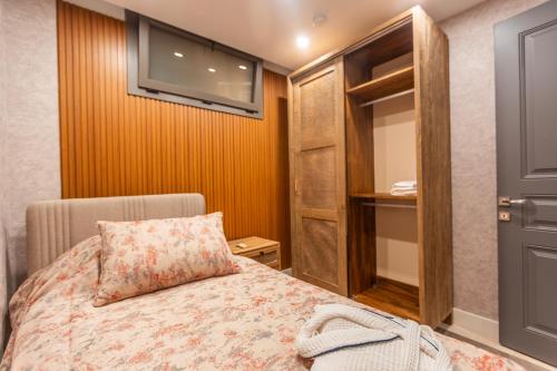 a bedroom with a bed with a pillow and a window at Marje Villas Bodrum in Bodrum City