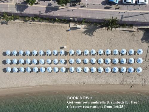 an overhead view of a row of umbrellas on the beach at Aegean Blue Beach Hotel in Nea Kalikratia