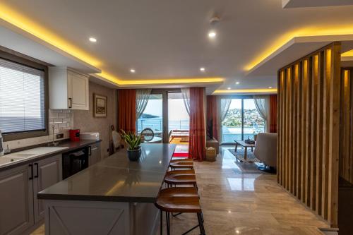 a kitchen with a table and chairs in a room at Marje Villas Bodrum in Bodrum City