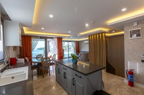 a kitchen with a counter top and a dining room at Marje Villas Bodrum in Bodrum City