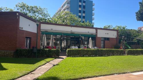 a brick building with a lawn in front of it at Maravilloso apartamento Delux in Blanes