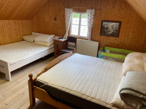 a bedroom with two beds and a window at Urige Berghütte in Fohnsdorf