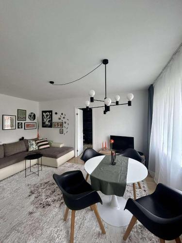 a living room with a table and chairs at Your Place in Tallinn - newly renovated! in Tallinn