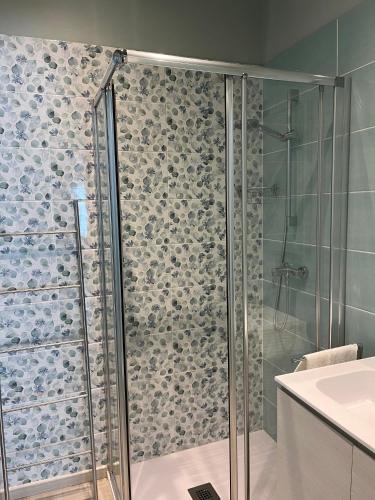 a bathroom with a shower with a glass door at Civico 18 Guest House in Cuneo