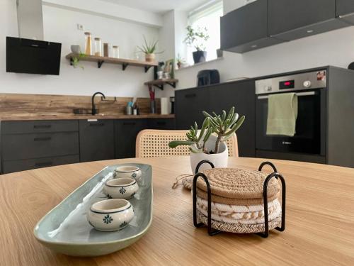 a wooden table with a tray with three tea cups on it at Appartement nähe Gruga-Messe und Klinik! in Essen