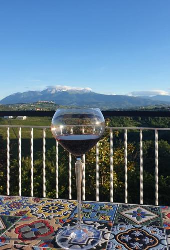 a glass of wine sitting on top of a table at Villa vista La Majella in Chieti