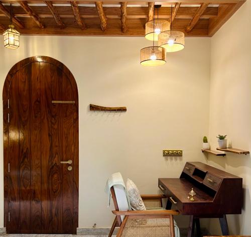 a room with a wooden door and a wooden desk at Shiv Sadan in Jaipur