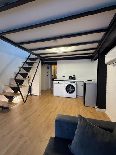 a living room with a couch and a staircase at Nest Apart Ortaköy in Istanbul