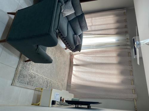 a room with a window with a curtain and a shutter at Aqua View in Bijilo