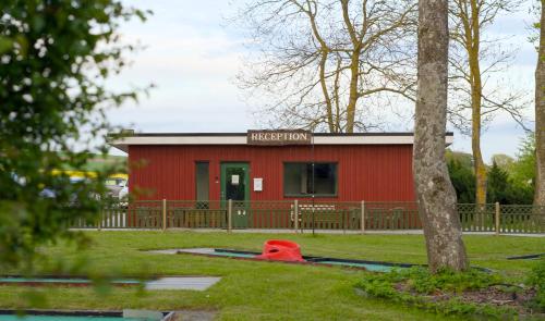a red building with a sign on top of it at GEG Hotel in Landskrona