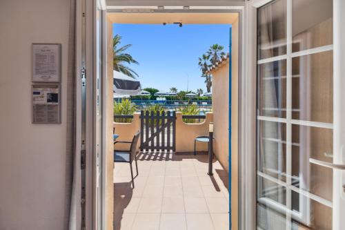 a door leading to a balcony with a view at Hôtel La Nartelle in Sainte-Maxime