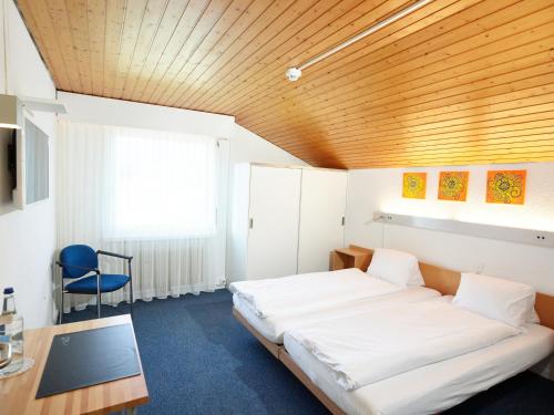 Postel nebo postele na pokoji v ubytování Erlebnisland Grizzlybär