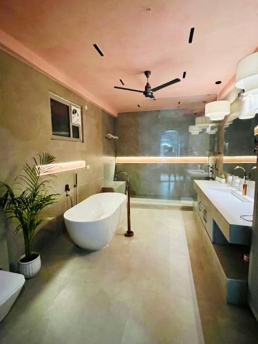 a bathroom with a large tub and two sinks at Shiv Sadan in Jaipur