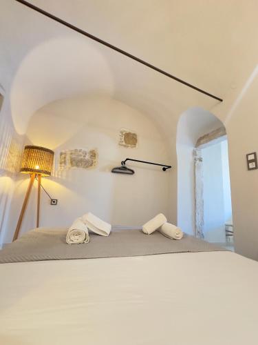 a bedroom with a bed with two towels on it at Arch Residence, studio 1, Apothika in Katarráktis