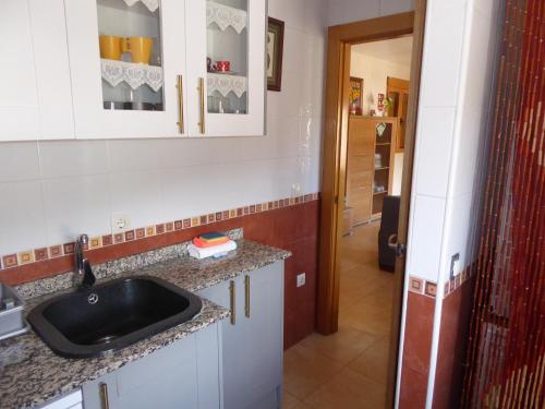 a kitchen with a sink and a counter top at Casa rural Butaka in Alcalá del Júcar