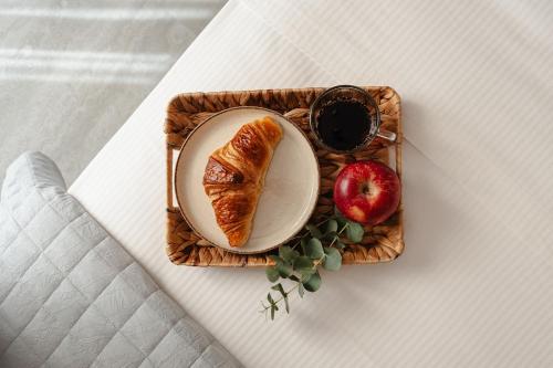 a plate of bread and an apple on a table at Phaistos Suites in Agios Prokopios