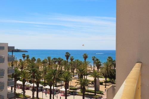 a view of the beach and palm trees from a building at Prime Location Penthouse with Stunning Sea Views in Salou