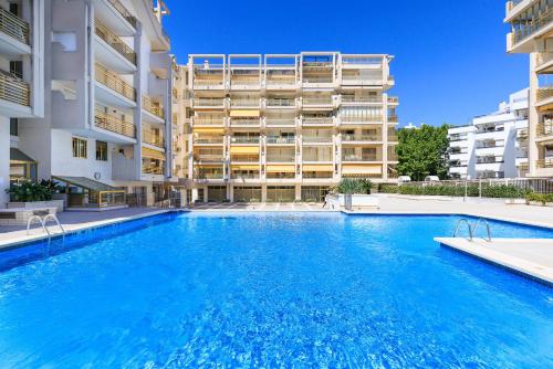 a large swimming pool in front of a building at Prime Location Penthouse with Stunning Sea Views in Salou