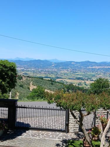 a white fence with a view of a valley at Poggio La Grognola in Cannara