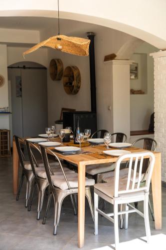 a wooden table with chairs and a dining room at Villa Bellavista in Marsanne