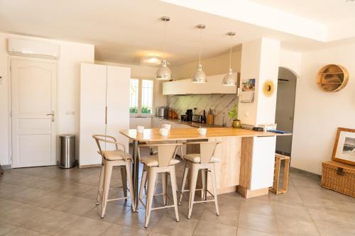 a kitchen with a table and chairs in a room at Villa Bellavista in Marsanne