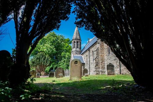 an old stone church with a tower and a grave at St Michaels Lodge in Richmond