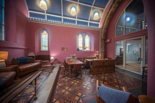 a large room with couches and a table and windows at St Michaels Lodge in Richmond