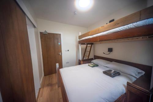 a bedroom with two bunk beds with white sheets at St Michaels Lodge in Richmond