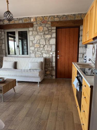 a living room with a couch and a table at Lavender House 1 - Agios Nikitas in Agios Nikitas