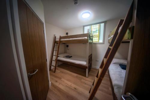 a small room with two bunk beds and a window at St Michaels Lodge in Richmond