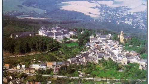 an aerial view of a town with buildings and trees at Hotel Morgensonne in Augustusburg