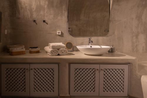 a bathroom with a sink and a mirror at The Wine Nest in Megalokhori