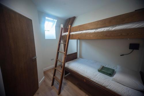a bedroom with two bunk beds with a ladder at St Michaels Lodge in Richmond