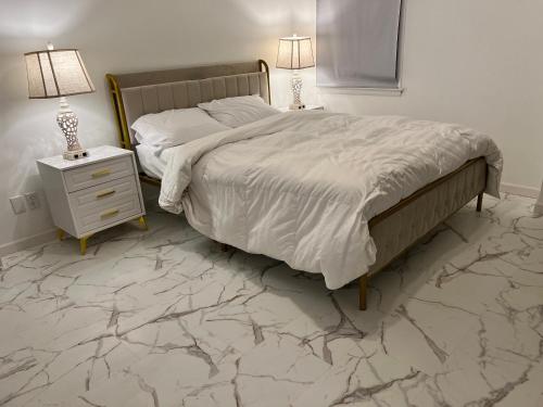 a bedroom with a bed and a night stand with two lamps at CampRV Main Lodge in Elkins