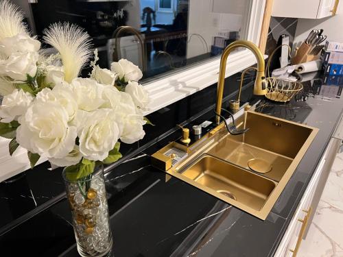 a kitchen counter with a sink and a vase of flowers at CampRV Main Lodge in Elkins