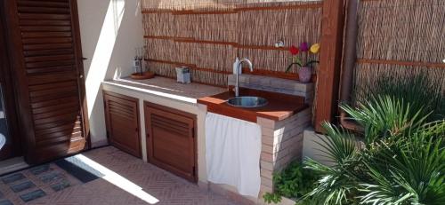 a kitchen with a sink on a patio at Il Mare nel Cuore in Custonaci