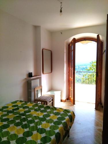 a bedroom with a bed and an open door to a balcony at Villa vista La Majella in Chieti