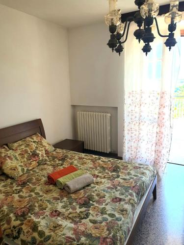 a bedroom with a bed with a floral bedspread at Villa vista La Majella in Chieti