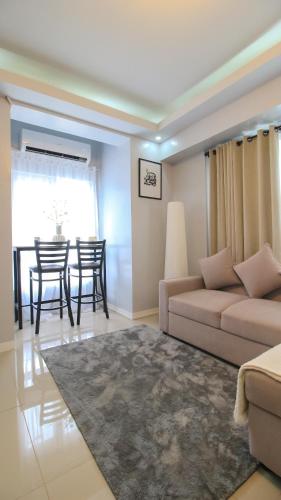 a living room with a couch and a table at Urban Oasis with Skyline View in Manila