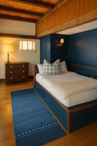 a bedroom with a bed with a blue wall at Magical Post And Beam Loft Downtown Newport! in Newport