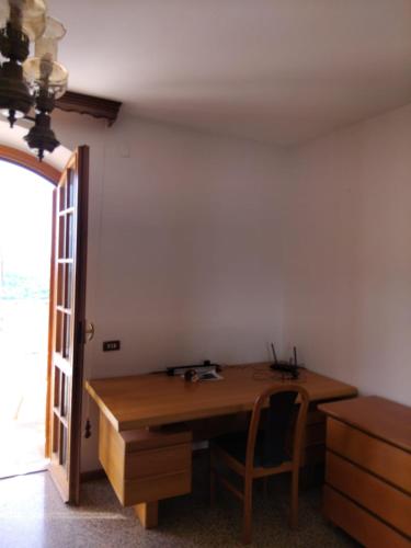 a room with a wooden table and a chair at Villa vista La Majella in Chieti
