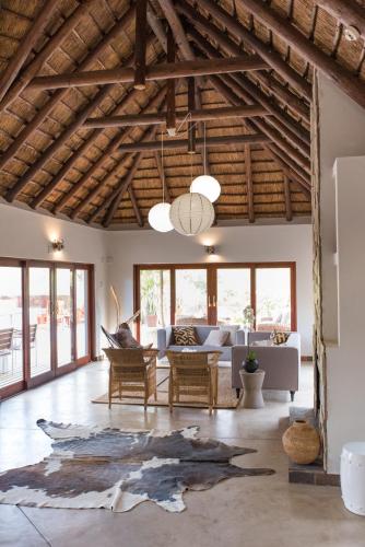 a living room with a couch and a table at Unembeza Boutique Lodge & Spa in Hoedspruit