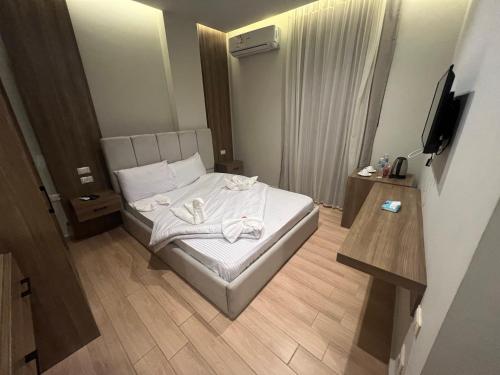 a small hotel room with a bed and a television at Isis pyramids in Giza