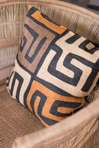 a pillow sitting on top of a wicker chair at Unembeza Boutique Lodge & Spa in Hoedspruit