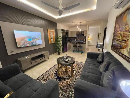 a living room with a couch and a table at Aurum Heights Gateway Prestige Luxury Apartments - Gulberg Lahore in Lahore