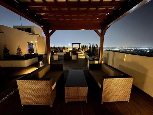 a balcony with a table and chairs on a building at Aurum Heights Gateway Prestige Luxury Apartments - Gulberg Lahore in Lahore