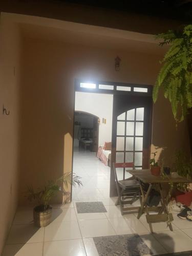 a living room with a table and a dining room at Casa para alugar em Salvador in Salvador
