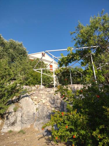 a house on top of a hill with trees at IthakiHouse II in Vathi, Ithaka